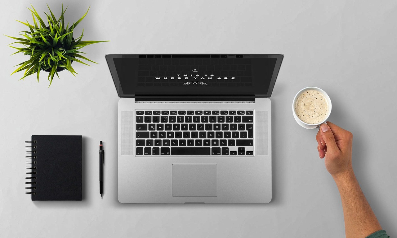 Laptop, coffee, arm — Financing Options for Window Replacement in Layton
