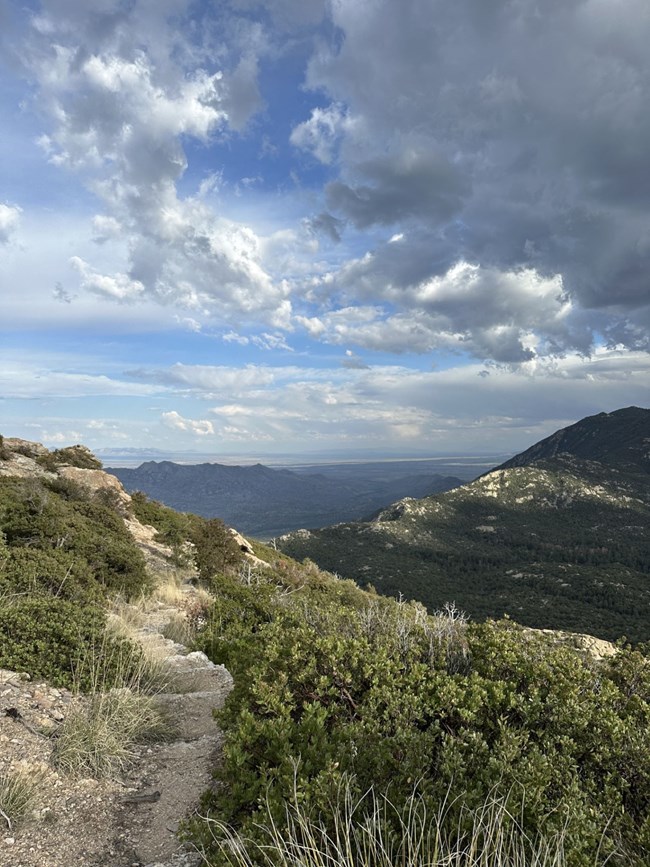 Scenic view of a mountainous landscape with clouds in the sky
